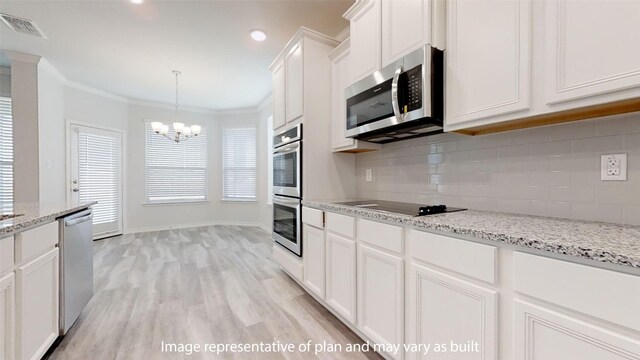 kitchen featuring white cabinetry, hanging light fixtures, stainless steel appliances, a notable chandelier, and light wood-type flooring