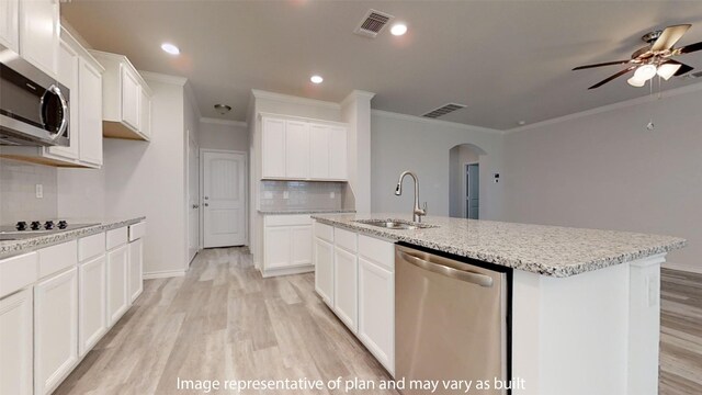 kitchen featuring white cabinets, sink, an island with sink, and stainless steel appliances