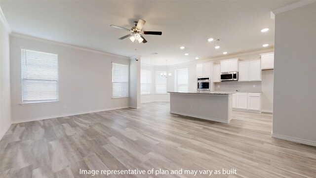 kitchen featuring white cabinetry, plenty of natural light, and a kitchen island with sink