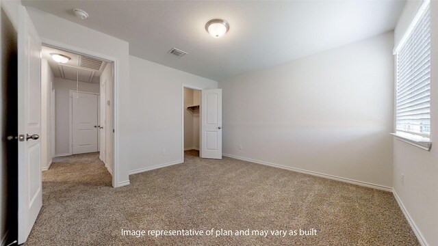 unfurnished bedroom featuring a closet and light colored carpet