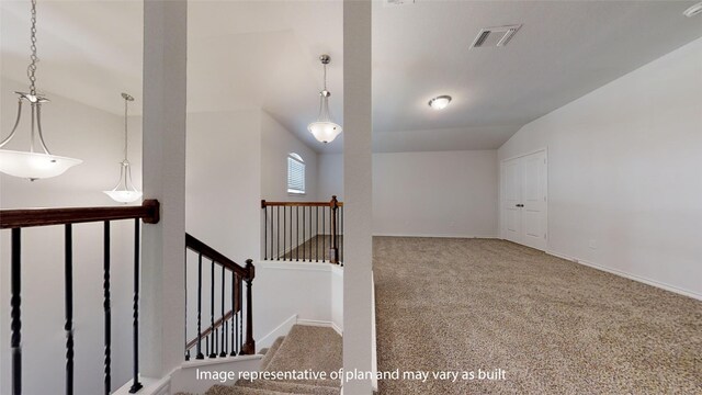 stairs with carpet floors and vaulted ceiling