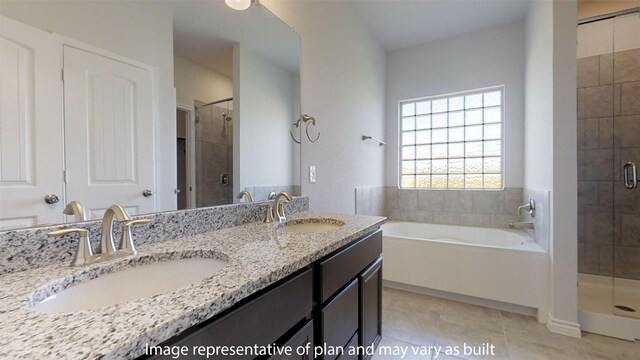 bathroom featuring plus walk in shower, vanity, and tile patterned floors