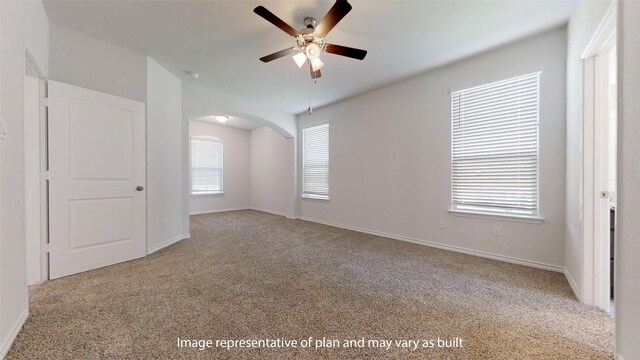 carpeted empty room featuring ceiling fan