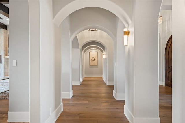 corridor with hardwood / wood-style flooring