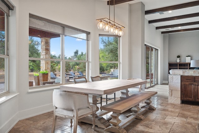 dining room featuring beam ceiling and a notable chandelier