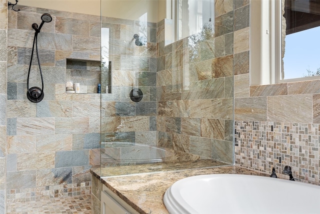 bathroom featuring separate shower and tub