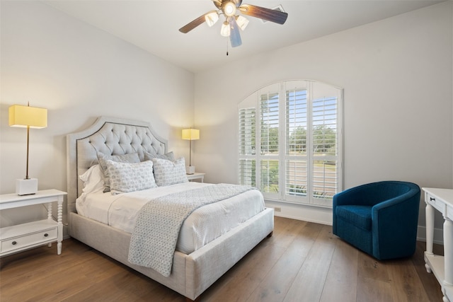 bedroom with ceiling fan and dark hardwood / wood-style flooring