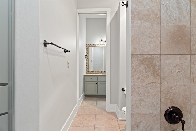 bathroom with tile patterned flooring, vanity, and toilet