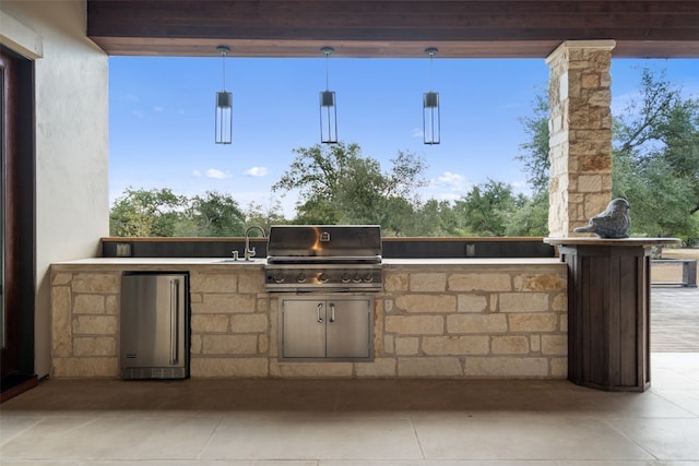 view of patio / terrace with sink, an outdoor kitchen, and a grill