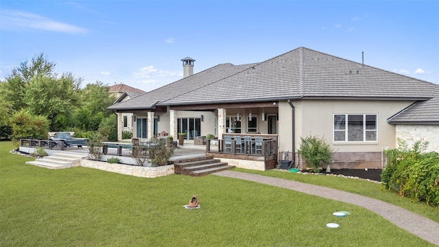 rear view of house with a lawn