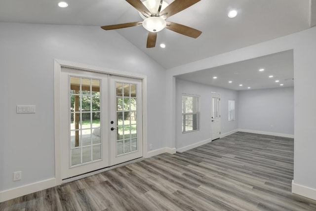 interior space featuring french doors, light hardwood / wood-style floors, vaulted ceiling, and ceiling fan