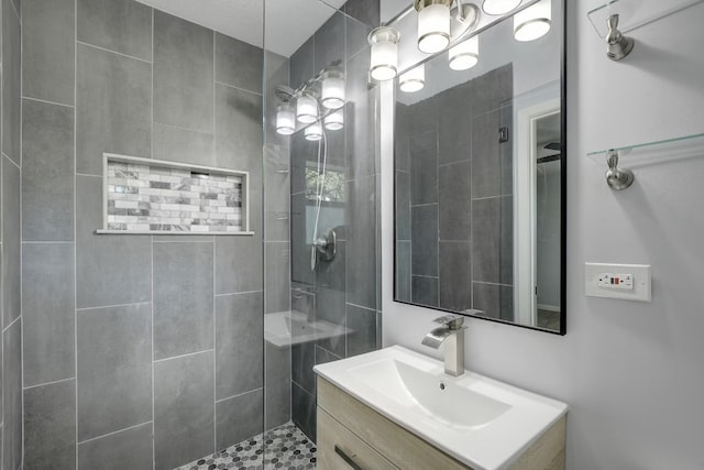 bathroom featuring vanity and tiled shower