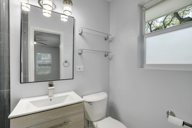 bathroom with vanity, toilet, and ceiling fan