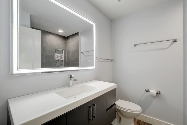 bathroom featuring hardwood / wood-style floors, vanity, and toilet