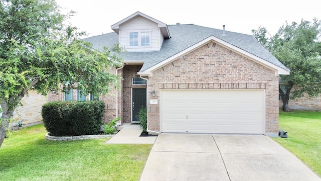 view of front of home featuring a front yard and a garage