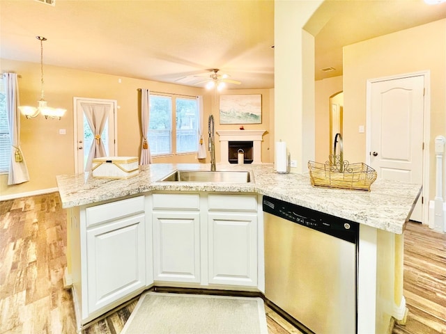 kitchen featuring light wood-type flooring, sink, pendant lighting, dishwasher, and white cabinetry