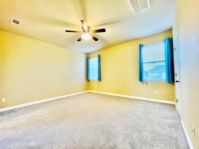 carpeted spare room featuring ceiling fan