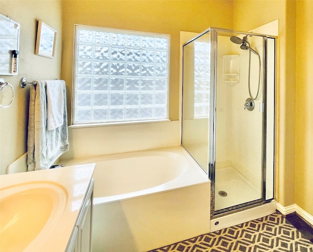 bathroom featuring tile patterned flooring, vanity, and independent shower and bath