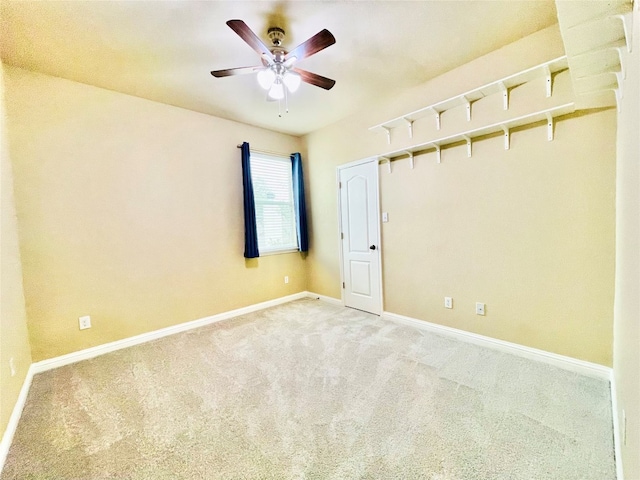 carpeted spare room with ceiling fan