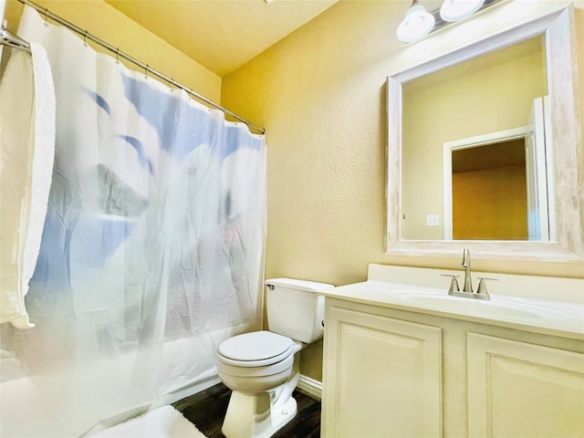 full bathroom with shower / bath combo, vanity, hardwood / wood-style flooring, and toilet