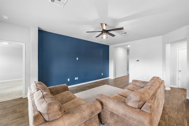 living room featuring dark hardwood / wood-style flooring and ceiling fan