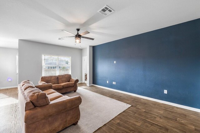 living room with hardwood / wood-style flooring and ceiling fan