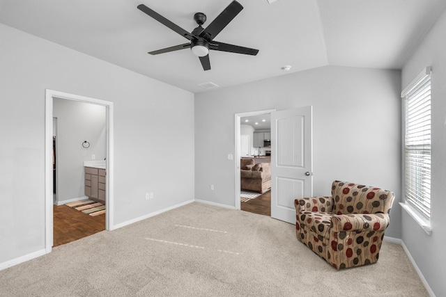 living area with carpet flooring, ceiling fan, and lofted ceiling