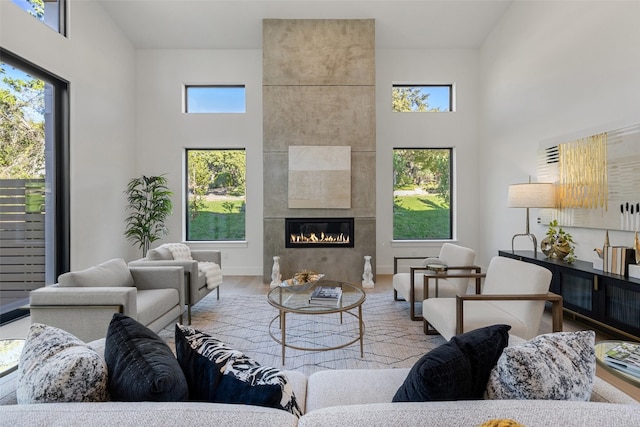 living room with high vaulted ceiling, light hardwood / wood-style flooring, and plenty of natural light