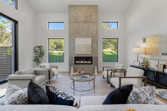 419 Hazeltine Dr, Lakeway, TX 78734 - living room featuring a towering ceiling, a tile fireplace, and wood finished floors