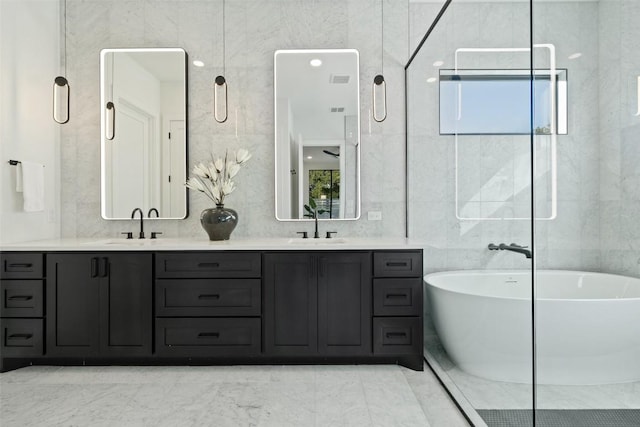 419 Hazeltine Dr, Lakeway, TX 78734 - bathroom with a freestanding bath, double vanity, and tile walls