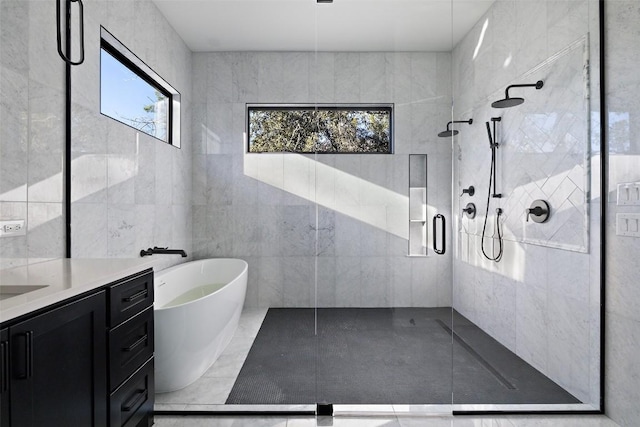 419 Hazeltine Dr, Lakeway, TX 78734 - bathroom with a shower stall, vanity, tile walls, and a freestanding tub