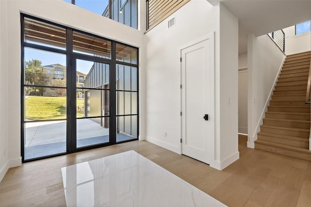419 Hazeltine Dr, Lakeway, TX 78734 - entrance foyer with stairway, wood finished floors, french doors, and a towering ceiling