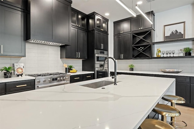 419 Hazeltine Dr, Lakeway, TX 78734 - kitchen featuring high end stainless steel range oven, open shelves, a kitchen breakfast bar, dark cabinets, and ventilation hood