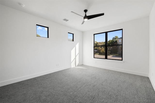 spare room featuring ceiling fan and carpet floors