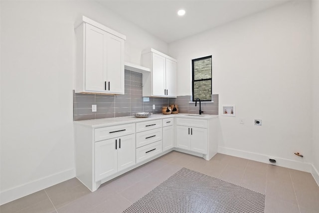 419 Hazeltine Dr, Lakeway, TX 78734 - kitchen with backsplash, light countertops, light tile patterned flooring, white cabinets, and recessed lighting