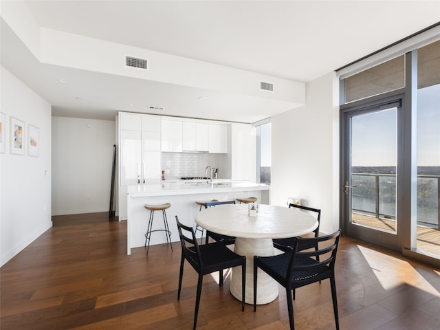 dining space featuring dark wood-type flooring