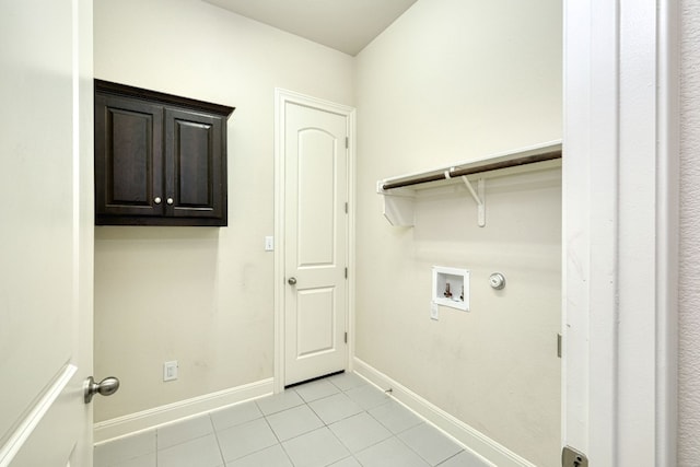 laundry room with cabinets, washer hookup, and light tile patterned flooring