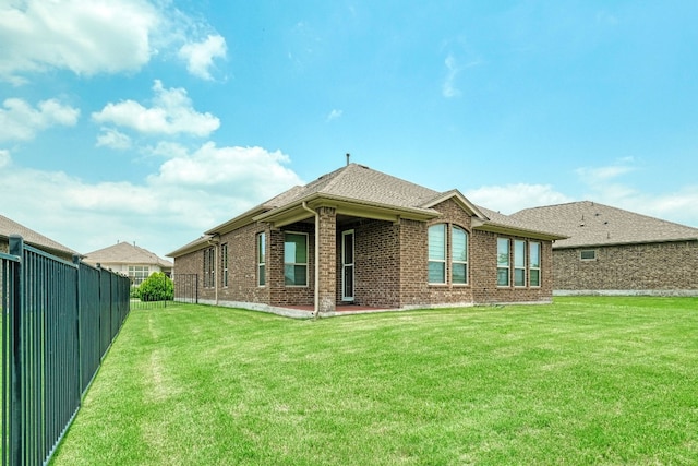 rear view of house with a lawn