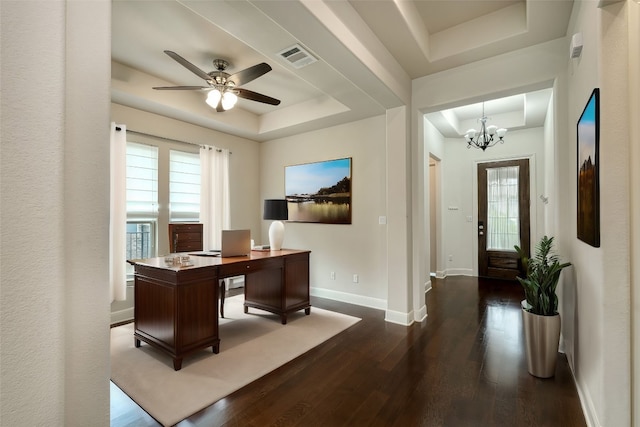 office with a raised ceiling, ceiling fan with notable chandelier, and dark hardwood / wood-style floors