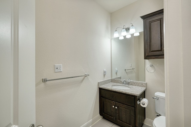 bathroom with tile patterned floors, vanity, and toilet