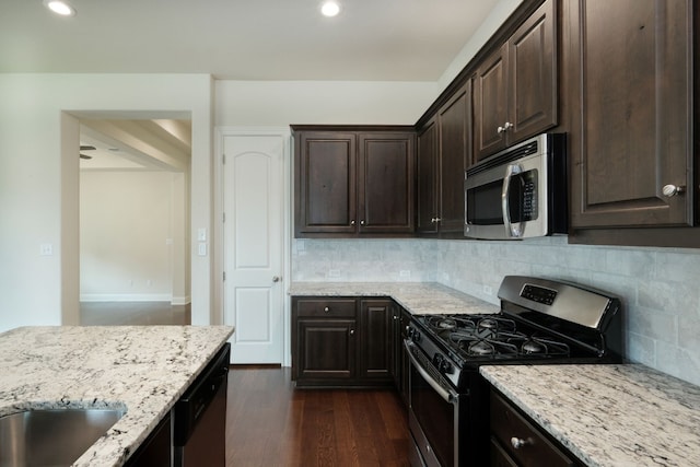 kitchen with decorative backsplash, dark brown cabinetry, stainless steel appliances, and dark wood-type flooring