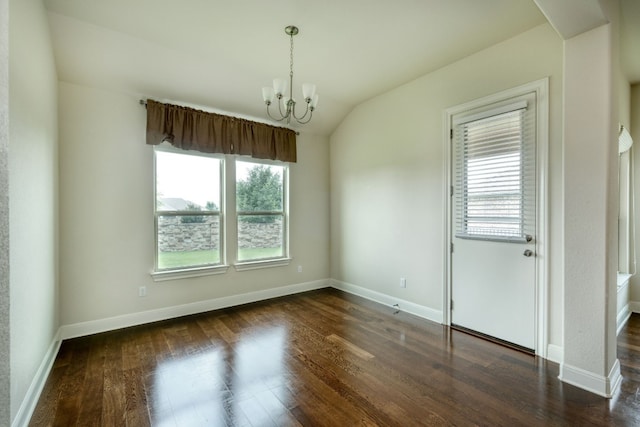 spare room featuring dark hardwood / wood-style flooring, lofted ceiling, and a chandelier