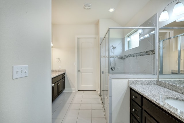 bathroom with vaulted ceiling, tile patterned flooring, vanity, and an enclosed shower