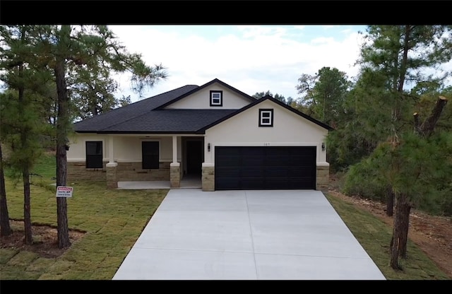 view of front facade with a front yard and a garage