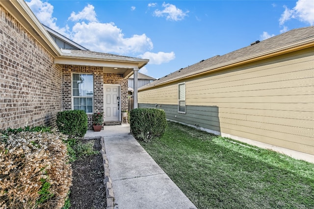 entrance to property with a lawn