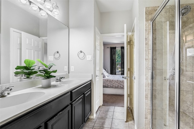 bathroom featuring tile patterned floors, vanity, and a shower with door