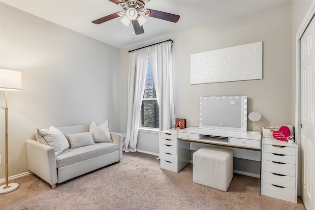 carpeted home office featuring ceiling fan