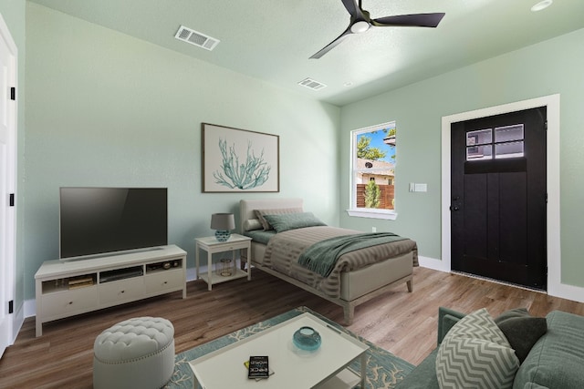 bedroom with hardwood / wood-style floors and ceiling fan