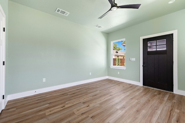 entrance foyer with ceiling fan and light hardwood / wood-style flooring