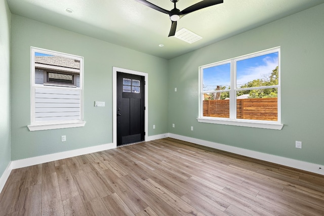 foyer with ceiling fan and light hardwood / wood-style flooring